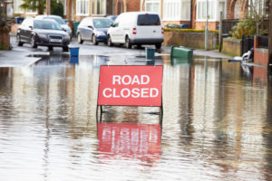 Warning Traffic Sign On Flooded Road to illustrate Flood Damage Restoration Seattle